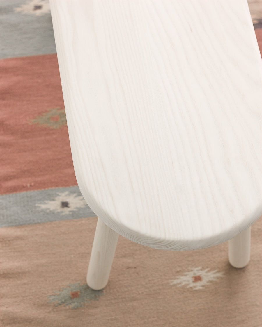 White chair on a patterned rug