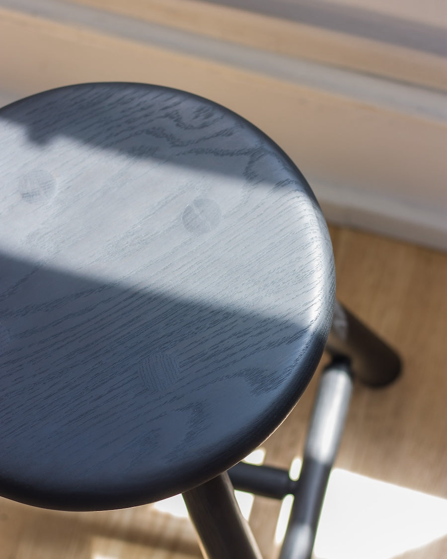 Close-up of a black stool with a blurred background